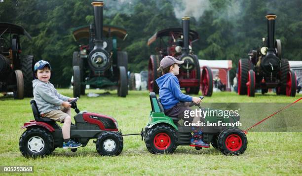Two youngsters are pulled along in replica tractors during the Duncombe Park Steam Rally on July 1, 2017 in Helmsley, United Kingdom. Held annually...