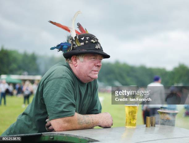 Man leans against his miniature steam engine with a pint during the Duncombe Park Steam Rally on July 1, 2017 in Helmsley, United Kingdom. Held...