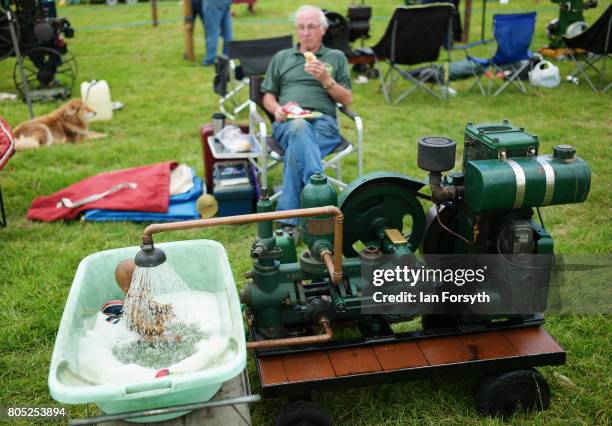 Man sits with his static engine display during the Duncombe Park Steam Rally on July 1, 2017 in Helmsley, United Kingdom. Held annually in the...