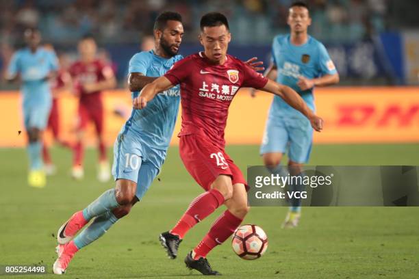 He Guan of Shanghai SIPG and Alex Teixeira of Jiangsu Suning compete for the ball during 2017 Chinese Super League 15th round match between Jiangsu...