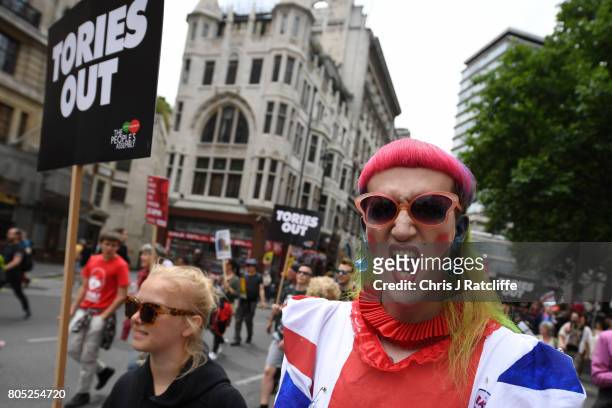 Demonstrators carry placards during the 'Not One Day More' march on July 1, 2017 in London, England. Thousands of protesters joined the anti-Tory...