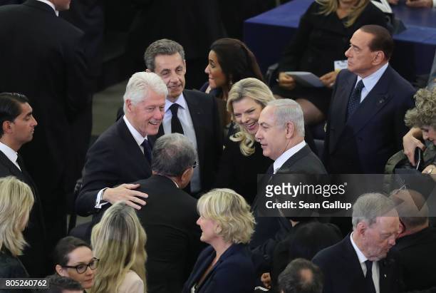 Former U.S. President Bill Clinton , Israeli Prime Minister Benjamin Netanyahu and his wife Sara pause chat prior to a memorial ceremony for former...