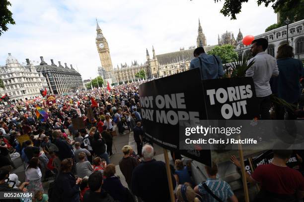 Crowds gather as they wait for Labour Party leader, Jeremy Corbyn to speak during the 'Not One Day More' march at Parliament Square on July 1, 2017...