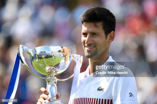 Novak Djokovic of Serbia celebrates with the trophy after victory in the mens singles final against Gael Monfils of France on day seven of the Aegon...
