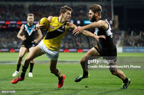 Oleg Markov of the Tigers is tackled by Justin Westhoff of the Power during the 2017 AFL round 15 match between the Port Adelaide Power and the...