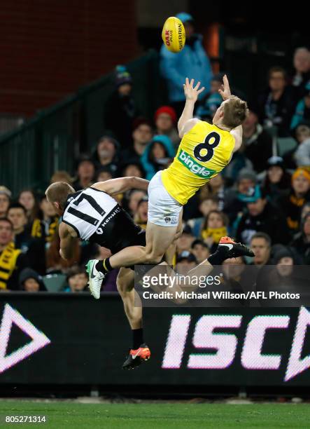 Jack Riewoldt of the Tigers marks the ball over Tom Clurey of the Power during the 2017 AFL round 15 match between the Port Adelaide Power and the...