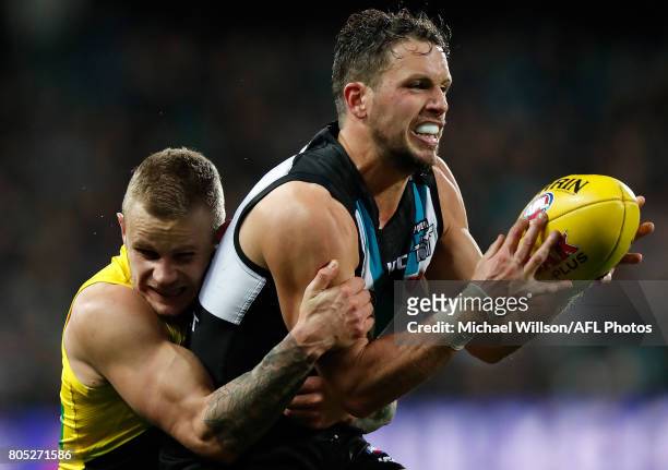 Travis Boak of the Power is tackled by Brandon Ellis of the Tigers during the 2017 AFL round 15 match between the Port Adelaide Power and the...