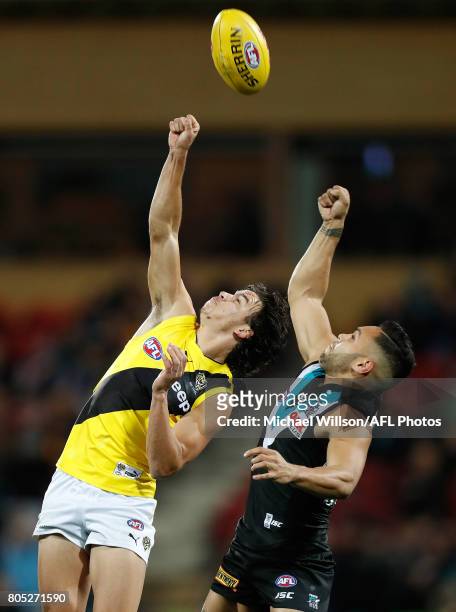 Daniel Rioli of the Tigers and Jarman Impey of the Power compete for the ball during the 2017 AFL round 15 match between the Port Adelaide Power and...
