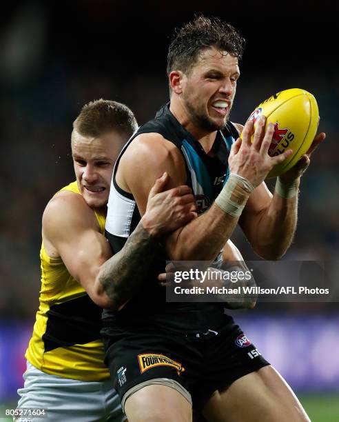 Travis Boak of the Power is tackled by Brandon Ellis of the Tigers during the 2017 AFL round 15 match between the Port Adelaide Power and the...