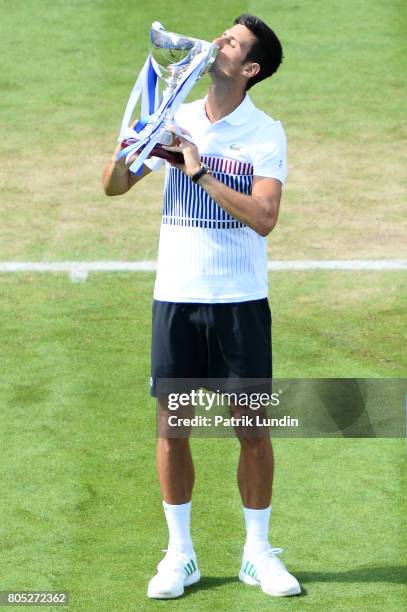 Novak Djokovic of Serbia kisses the trophy after victory during the Final match against Gael Monfils of France on day seven on July 1, 2017 in...