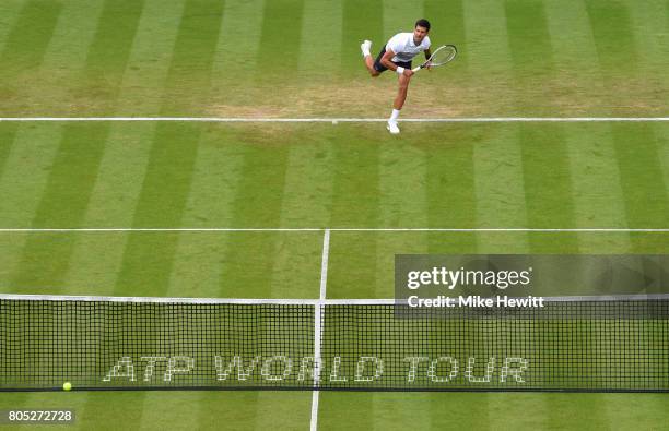 Novak Djokovic of Serbia serves during his mens singles final against Gael Monfils of France on day seven of the Aegon International Eastbourne at...