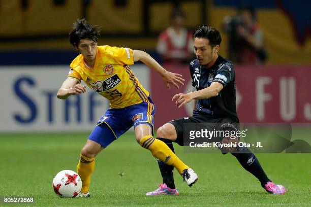 Yoshihiro Nakano of Vegalta Sendai and Jungo Fujimoto of Gamba Osaka compete for the ball during the J.League J1 match between Vegalta Sendai and...