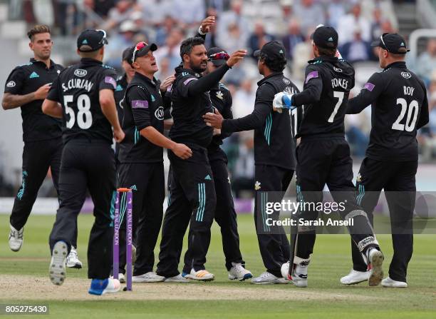 Ravi Rampaul of Surrey celebrates with teammates after taking the wicket of Nottinghamshire's Riki Wessels during the match between Nottinghamshire...