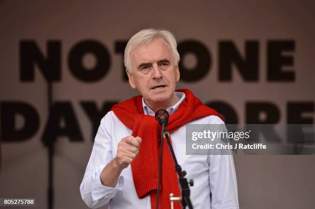 Shadow Chancellor of the Exchequer John McDonnell speaks to demonstrators during the 'Not One Day More' march at Parliament Square on July 1, 2017 in...