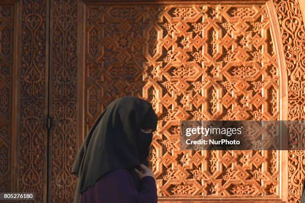 View of a woman wearing a burka walking inside Fes medina. On Saturday, July 1 in Fes, Morocco.