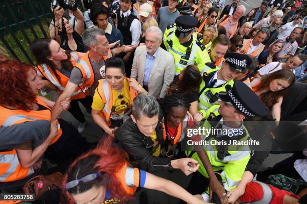 Labour Party leader Jeremy Corbyn is escorted through the crowd by police after speaking to demonstrators during the 'Not One Day More' march at...