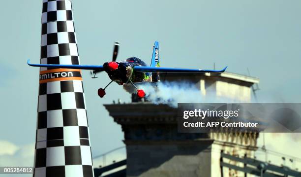 Third placed Czech Petr Kopfstein completes with 01:01.296 by his Zivko Edge 540 plane during the qualification session of the Red Bull Air Race...