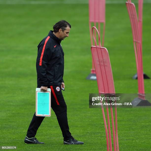 Head coach Juan Antonio Pizzi walks over the pitch during a Chile training session ahead of their FIFA Confederations Cup Russia 2017 final against...