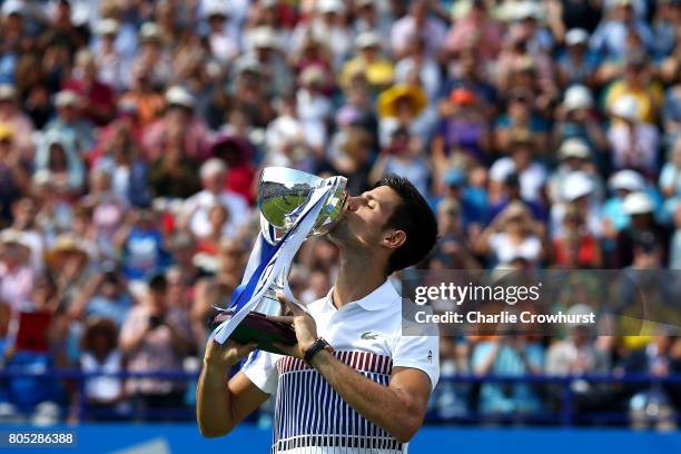 Novak Djokovic of Serbia celebrates with the trophy after winning the men's singles final against Gael Monfils of France during day seven of the...