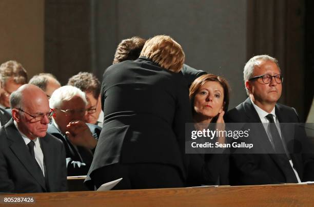 German Chancellor Angela Merkel embraces a guest prior to a requiem for former German Chancellor Helmut Kohl at the Speyer cathedral on July 1, 2017...