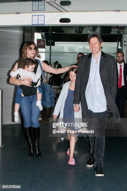 Actress Milla Jovovitch, her daughters Dashiel Edan Anderson and Ever Gabo Anderson and her husband Paul W.S. Anderson arrive at Charles-de-Gaulle...