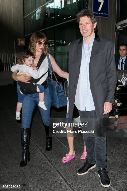 Actress Milla Jovovitch, her daughter Dashiel Edan Anderson and her husband Paul W.S. Anderson arrive at Charles-de-Gaulle airport on July 1, 2017 in...