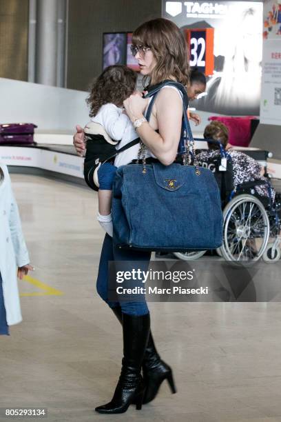 Actress Milla Jovovitch and her daughter Dashiel Edan Anderson arrive at Charles-de-Gaulle airport on July 1, 2017 in Paris, France.