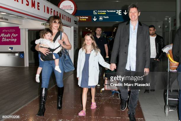 Actress Milla Jovovitch, her daughters Dashiel Edan Anderson and Ever Gabo Anderson and her husband Paul W.S. Anderson arrive at Charles-de-Gaulle...