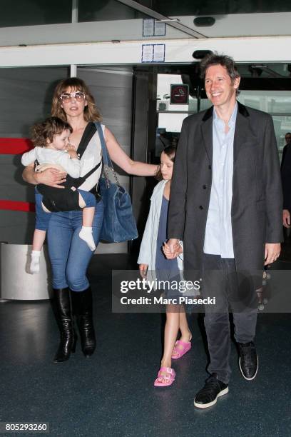 Actress Milla Jovovitch, her daughters Dashiel Edan Anderson and Ever Gabo Anderson and her husband Paul W.S. Anderson arrive at Charles-de-Gaulle...