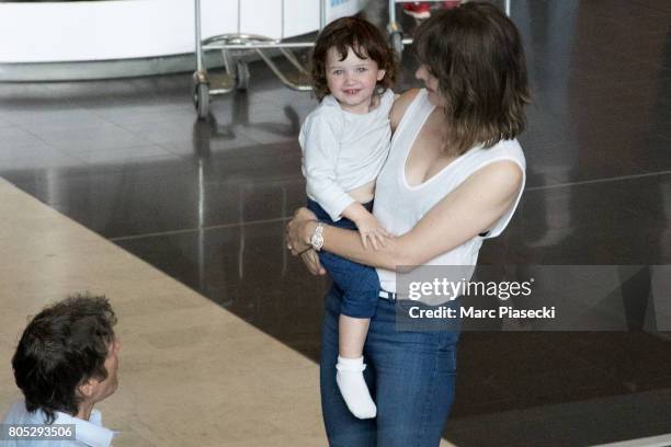 Paul W.S. Anderson, Dashiel Edan Anderson and actress Milla Jovovitch arrive at Charles-de-Gaulle airport on July 1, 2017 in Paris, France.