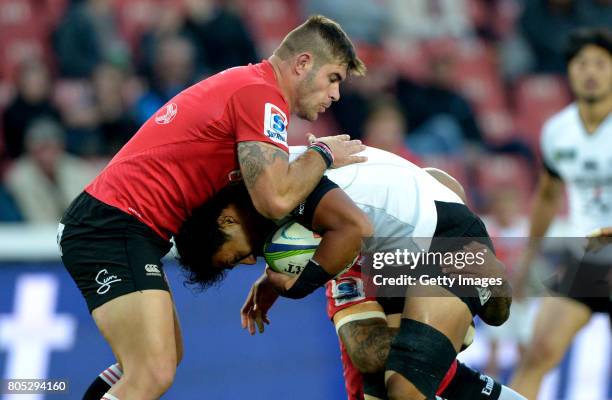 Yoshitaka Tokunaga of the Sunwolves tackled by Robbie Coetzee of the Lions during the Super Rugby match between Emirates Lions and Sunwolves at...