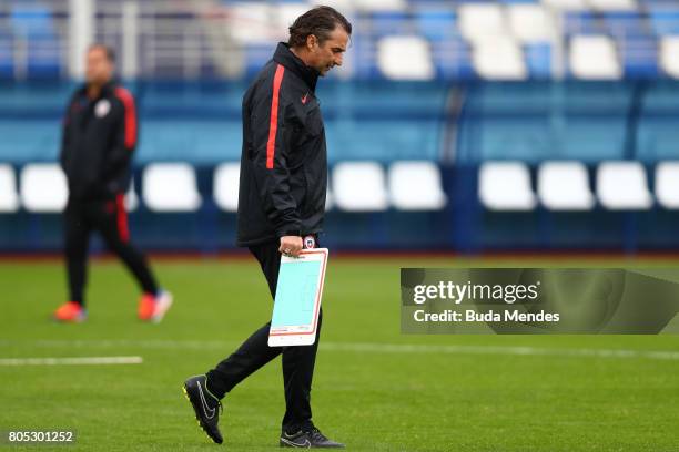 Head coach Juan Antonio Pizzi walks over the pitch during a Chile training session ahead of their FIFA Confederations Cup Russia 2017 final against...