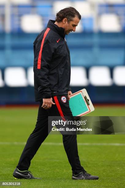 Head coach Juan Antonio Pizzi walks over the pitch during a Chile training session ahead of their FIFA Confederations Cup Russia 2017 final against...