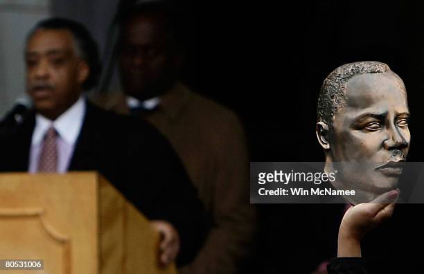 Participant in the rally prior to the "Recommitment March" holds up a bust of Martin Luther King Jr. As the Rev. Al Sharpton speaks April 4, 2008 in...