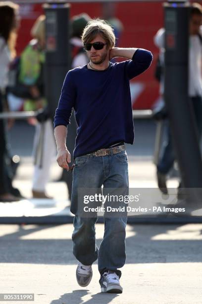 Sauber driver Nick Heidfeld arrives in the paddock for first practice during first practice at the Monza Circuit, Italy.