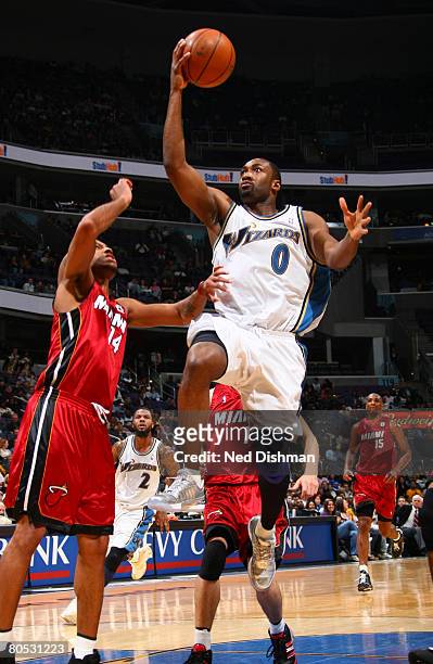 Gilbert Arenas of the Washington Wizards shoots against Daequan Cook of the Miami Heat at the Verizon Center on April 4, 2008 in Washington, DC. NOTE...