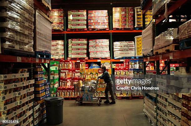 Shopper pushes a cart through the aisles of a Costco store April 4, 2008 in Tucson, Arizona. As the American economy slows down, consumers are...