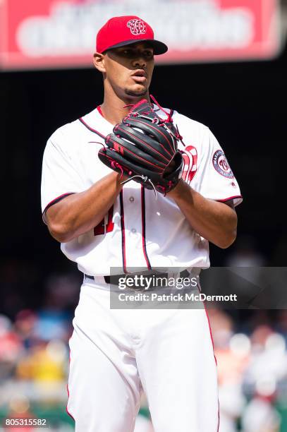 Starting pitcher Joe Ross of the Washington Nationals prepares to throw a pitch to a Cincinnati Reds batter in the first inning during a game at...