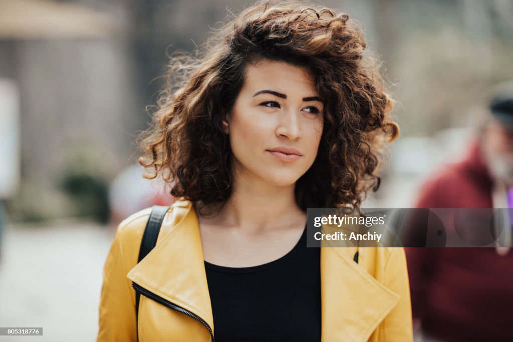 Adorable young woman with beautiful curly hair