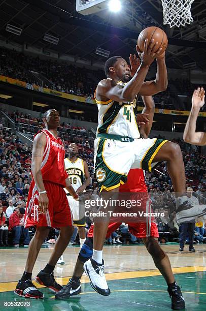 Adrian Griffin of the Seattle SuperSonics goes to the basket past the defense of Tracy McGrady of the Houston Rockets on April 4, 2008 at the Key...