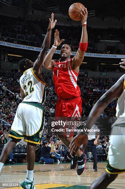 Tracy McGrady of the Houston Rockets goes to the basket against the defense of Jeff Green of the Seattle SuperSonics on April 4, 2008 at the Key...