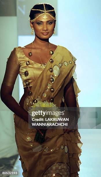 In this picture taken January 27, 2008 shows a Sri Lankan model displaying a saree with traditional batik design motifs at the annual fashion week in...