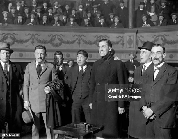 Ted 'Kid' Lewis, second left, and Georges Carpentier, fifth left, after the weigh in at The Ring, Blackfriars Road. Left to right; unidentified; Ted...