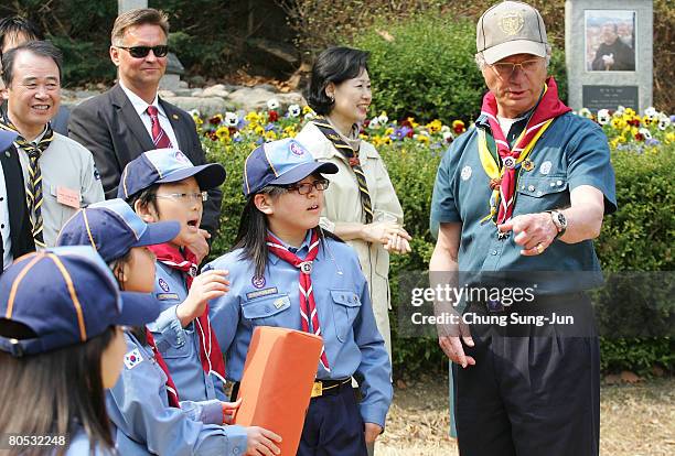 King Carl XVI Gustaf of Sweden talk with South Korean scout children during a meeting with boy scout event at the Soongeui elementary school on April...