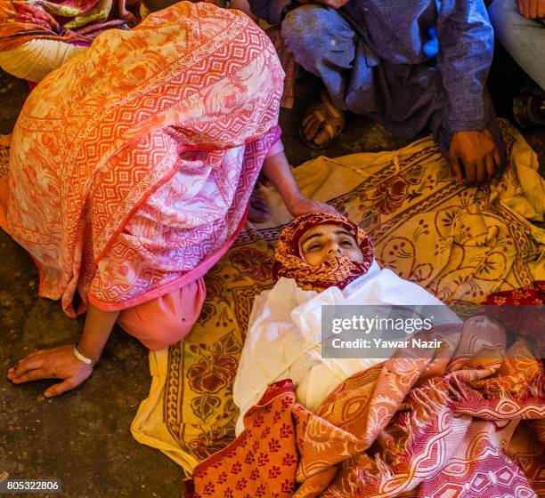 Relative mourns near the body of Tahira Begum, a civilian after she was killed near the gun battle site on July 1, 2017 in Dialgam, 70 km south of...