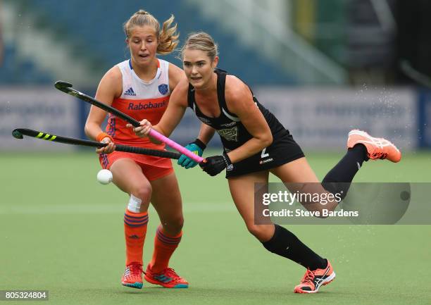 Samantha Harrison of New Zealand breaks away from Xan de Waard of the Netherlands during the Fintro Hockey World League semi final game between the...