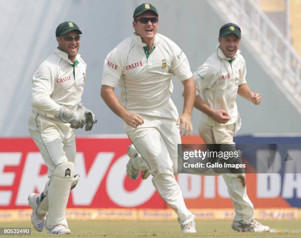 Graeme Smith of South Africa celebrates after the catch by AB de Villiers to get the wicket of Rahul Dravid for 17 runs during Day 3 of the second...