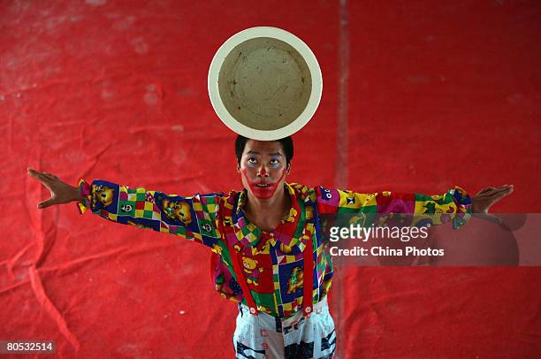 An acrobat performs during an acrobatic show on April 4, 2008 in Chongqing Municipality, China. China's tradition of acrobatics is believed to date...