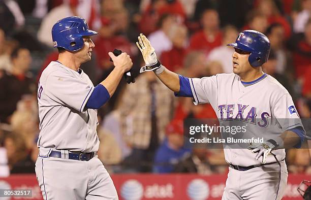 Ben Broussard and Gerald Laird of the Texas Rangers celebrate scoring in the eighth inning against the Los Angeles Angels of Anaheim at Angels...