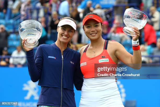 Martina Hingis and Yung-Jan Chan celebrate with trophies after winning their women's doubles final match against of Ashleigh Barty and Casey...